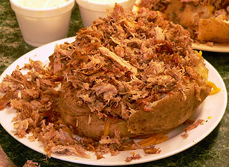 Baked potato piled with chopped Bar-B-Que pork